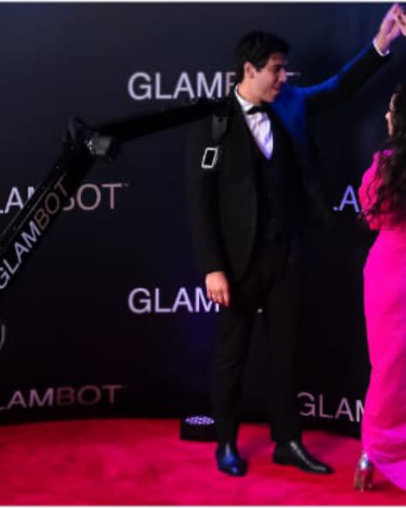 Guests posing for the Looking Forward Photo Booths Glambot experience at an event